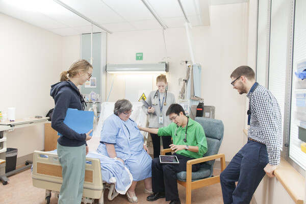Clerkship students at bedside with patient